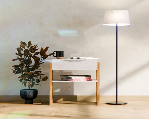 A minimalist reading setup with a soft ambient lamp illuminating an open book on a small side table